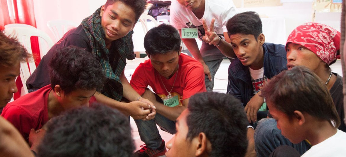 Youth volunteers and counsellors discussing protection against HIV through correct knowledge and skills, with a group of adolescent boys in Zamboanga City, Philippines. Photo: UNICEF/UNI177053/Palasi