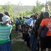 Haitians line up to receive bags of planting seeds in Jeremie, Grand'Anse Department, one of the areas hit hardest by Hurricane Matthew.