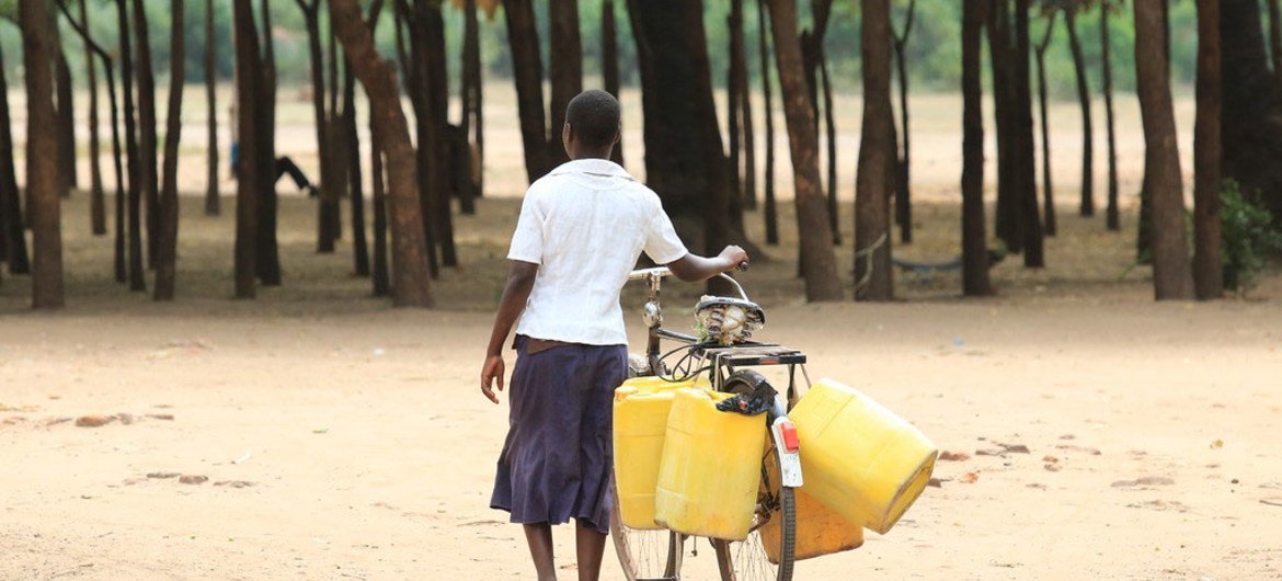 Woman on her way to collect water in drought stricken Chikwawa district, Malawi