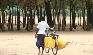 Woman on her way to collect water in drought stricken Chikwawa district, Malawi