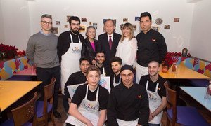 Secretary-General Ban Ki-moon (rear centre right) and his wife Yoo Soon-taek (rear centre left), pose with the staff of the Habibi & Hawara Restaurant in Vienna. the visit was aimed at showcasing the UN-System-Wide Campaign, “TOGETHER: Respect, Safety & Dignity for All.”