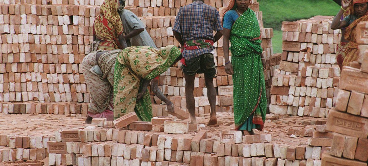Stacking bricks at a factory near Dhaka, Bangladesh, a least developed country.