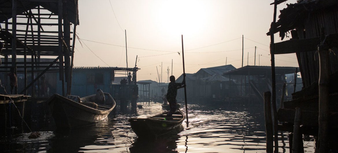In Lagos, Nigeria, residents navigate the polluted waters of Makoko, a fishing community mostly made up of structures on stilts above Lagos Lagoon, as smog spreads throughout the canals.