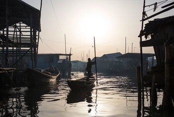 In Lagos, Nigeria, residents navigate the polluted waters of Makoko, a fishing community mostly made up of structures on stilts above Lagos Lagoon, as smog spreads throughout the canals.