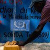 A resident of the town of Merger, an hour outside of Port au Prince, Haiti, fills his container at the water capture and distribution project.