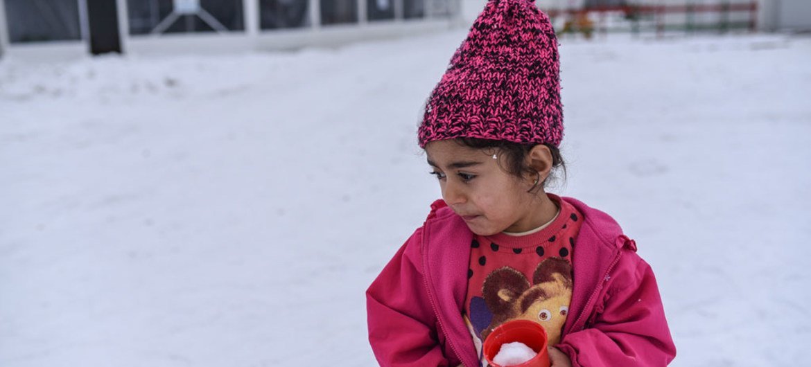 On 18 January 2017, in the Tabanovce refugee and migrant centre, former Yugoslav Republic of Macedonia, a Syrian girl, carries a plastic cup filled with snow.