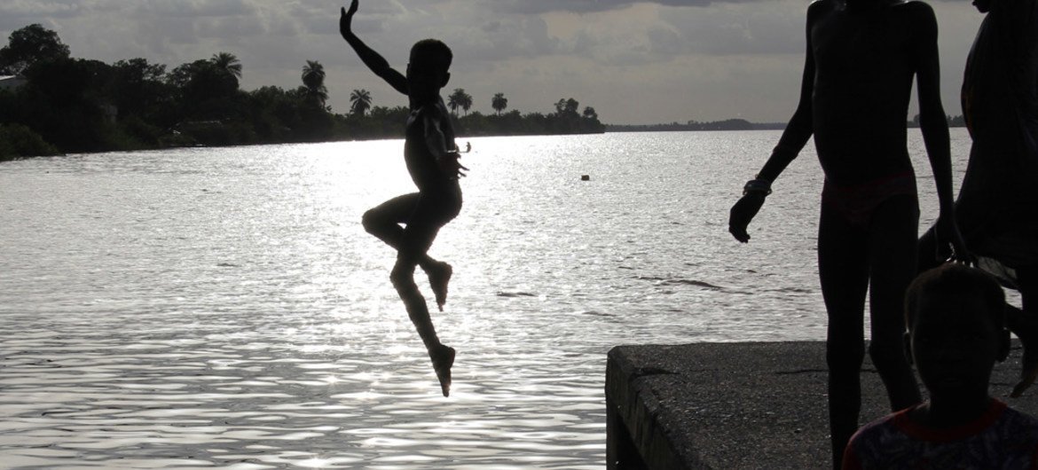 A child takes a dip in a river in the Gambia. (file)
