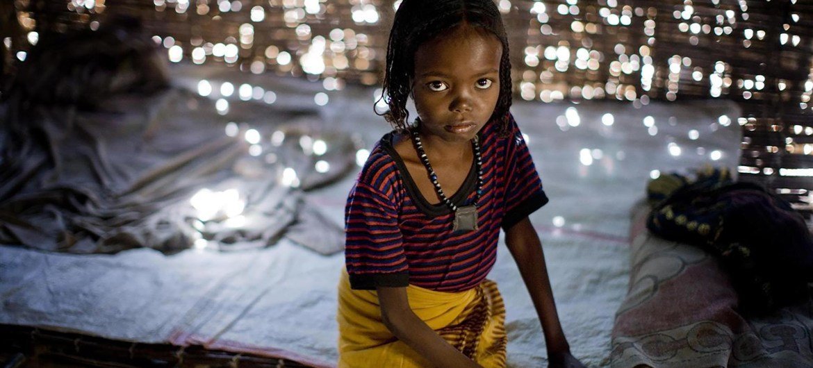 Fatima, 7, sits on a bed in her home in Afar region, Ethiopia. She was subjected to FGM/C when she was 1 year old.