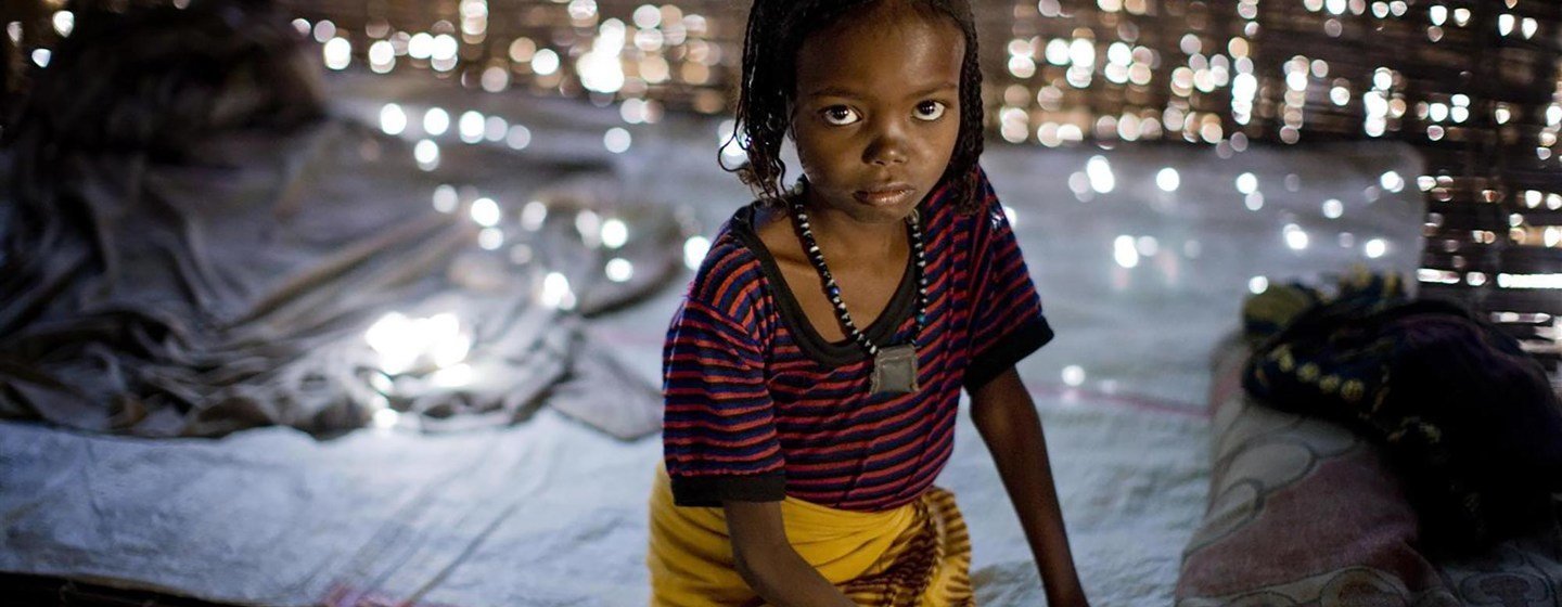 Fatima, 7, sits on a bed in her home in Afar region, Ethiopia. She was subjected to FGM/C when she was 1 year old.