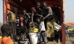 South Sudanese refugees get off the truck at Palorinya settlements in Uganda where each family will be given a piece of land for shelter.