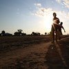 Two children carry water in Leer, Unity State in South Sudan, parts of which have been declared as famine-affected.