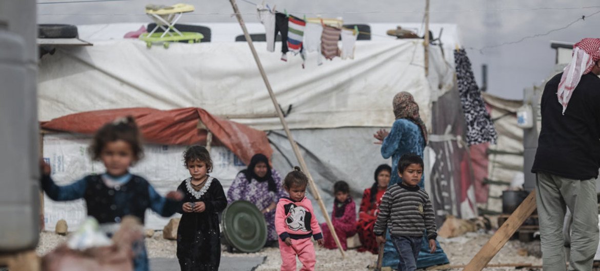 Young Syrian refugees walk through an informal settlement in the Bekaa Valley, eastern Lebanon.