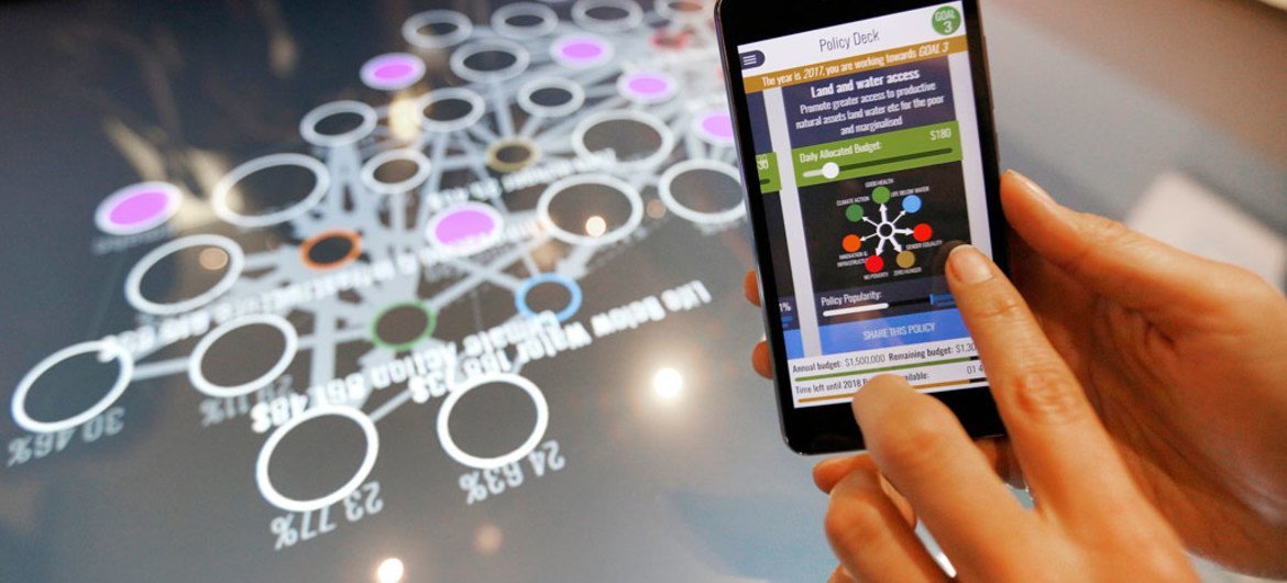 A delegate plays the Hive Mind 2030 on her mobile at the Global Festival of Ideas for Sustainable Development at the World Conference Center (WCC) in Bonn, 1 March 2017.