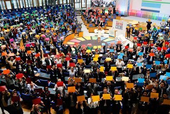 Delegates attending the Global Festival of Ideas for Sustainable Development form the SDG wheel at the World Conference Center (WCC) in Bonn, Germany.