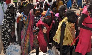 Women in Ganyiel, Unity state, South Sudan, collecting bags of food. The situation in Ganyiel is dire, with thousands of people having fled to the area from famine-stricken Leer and Mayendit counties.