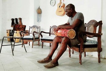 A drum maker crafts a batá drum, which is known as the sacred drum of Cuba.