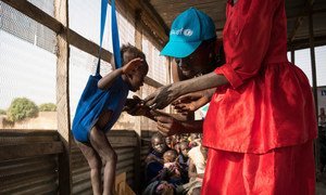 UNICEF Nutrition Officer Judy Jurua Michael (centre) weighs 13-month-old Alakaii during a malnutrition screening at Gabat Center, a UNICEF-supported Outpatient Therapeutic Programme in Aweil, South Sudan, Monday 13 March 2017.