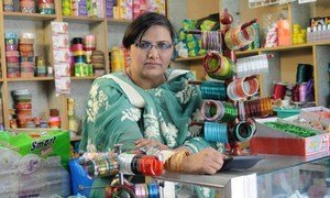 A women sells at her cosmetics shop and general store in Pakistan's Punjab province.