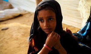 In Mazrak, Yemen, a five year-old girl, diagnosed as malnourished, is given a pink wristband to wear to show she has not been getting enough to eat.