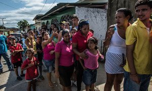 Shoppers wait in line for five hours to buy a ration of bread from a small bakery in Cumaná, Venezuela.