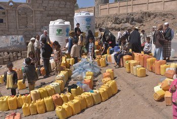 People queue to fill containers with water from a tank provided by UNICEF in Sana'a, Yemen. Some 14.5 million people in the country have no access to safe drinking water and adequate sanitation.