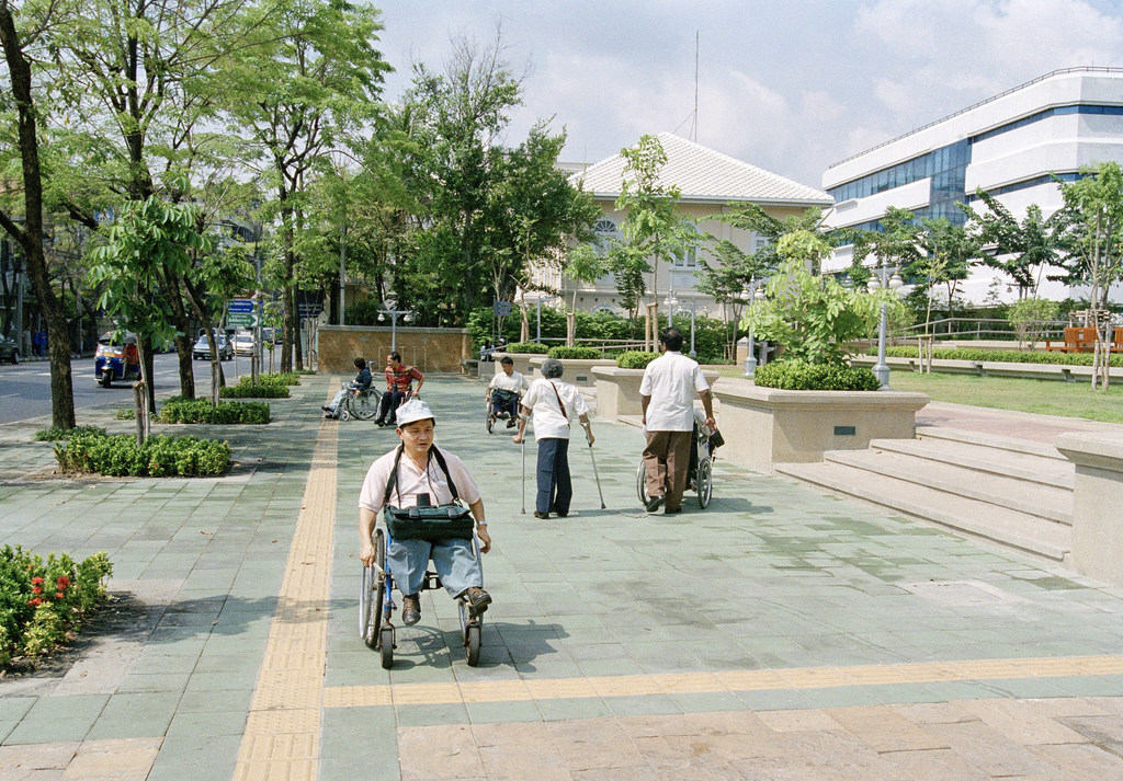 Un parque en Bangkok, Tailandia, donde se han instalado elementos de accesibilidad y asistencia, como guías detectables y avisos.
