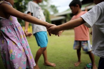 Children play outside their home at a shelter in the Philippines.
