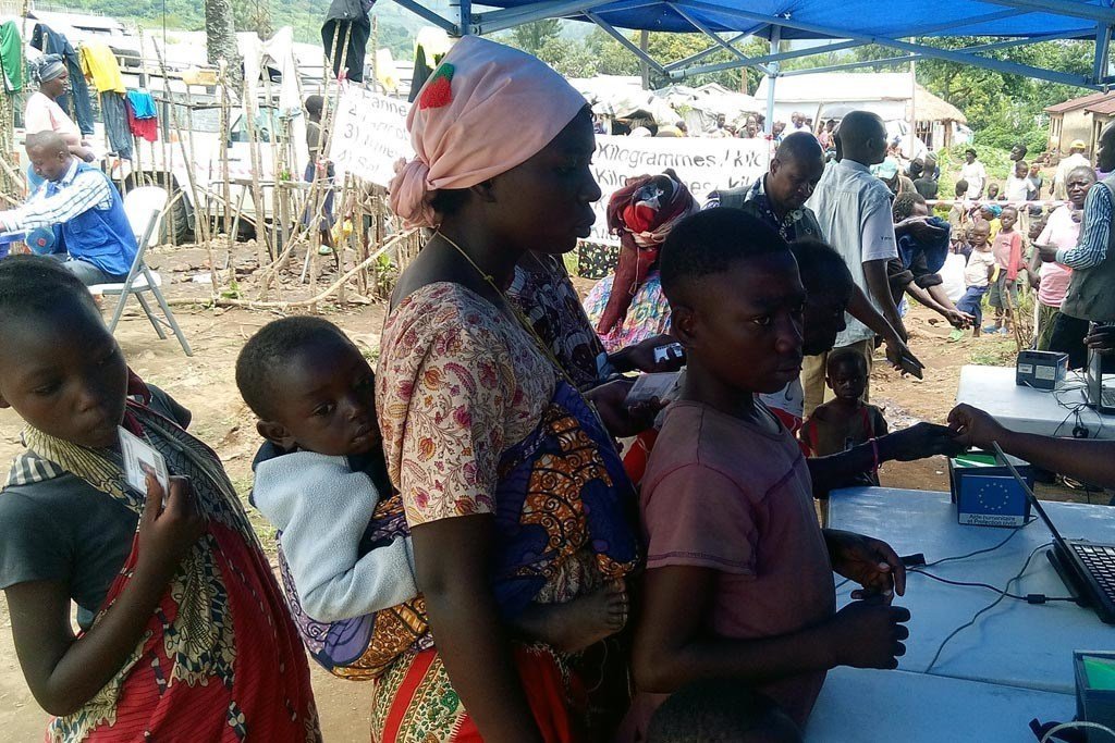 Internally displaced persons in Bweramana camp, North Kivu, Democratic Republic of the Congo, collect food items.