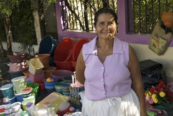 A woman in Valle, Honduras, sets up a street storefront to sell household items. She has built her business with the help of microcredit funds.