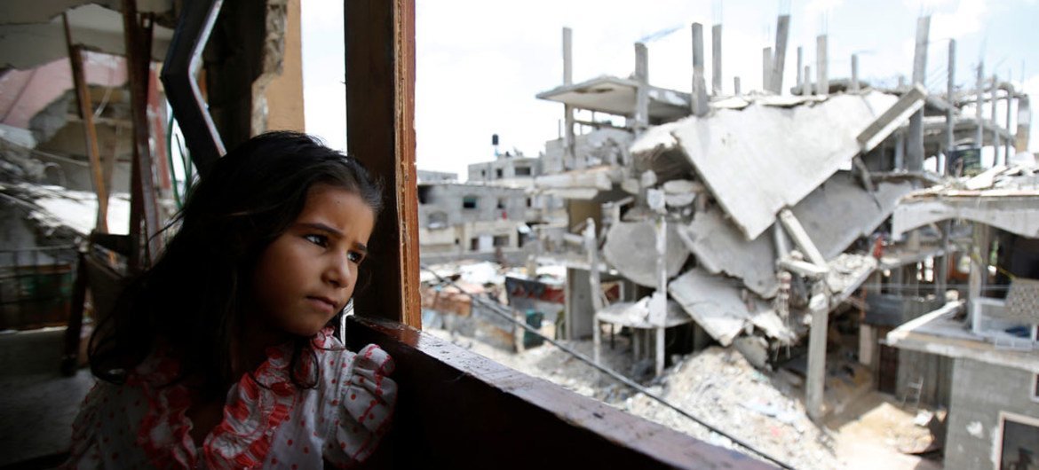 A Palestinian girl inside her family’s partially destroyed home, looks at the destruction outside, in the Shejaiya neighbourhood of Gaza City.