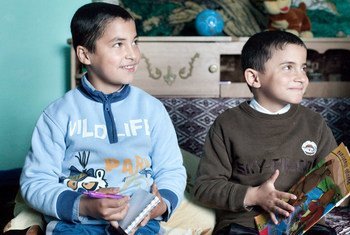 A nine-year-old child and his younger, eight-year-old, brother sit in their room, drawing and colouring. They are living live with foster parents in Lipova commune, Bacau county, Romania.