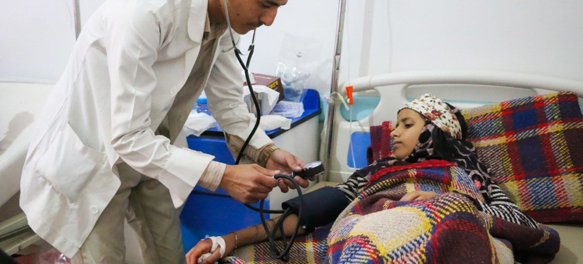 At the Al Sab’een Hospital in Sana’a, Yemen, a doctor checks on a girl suffering from cholera.