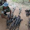 A UNOCI peacekeeper inspects weapons collected by militia members as part of the DDR exercise in Côte d'Ivoire. (file)