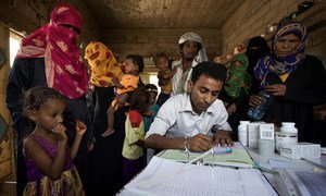 A medical worker registers young patients in the small rural village of An-Nassiri, located about 60 km from Al Hudaydah, Yemen. Only 45 per cent of health facilities in the war-torn country are currently functioning.