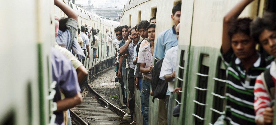 A view of passengers aboard trains connecting the suburbs of Kolkata, India.