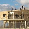 أرشيف: مجموعة من الفتيان يجلسون على سطح مبنى مهدم مهجور في غزة.