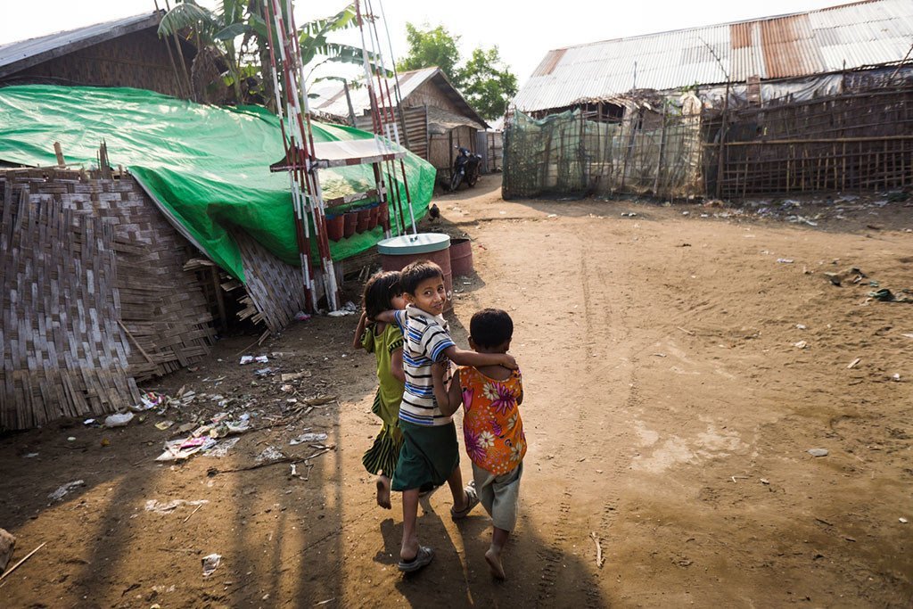 In this file photograph, children walk shelters at a camp for displaced persons in Rakhine state, Myanmar. Most of the displaced are women and children.