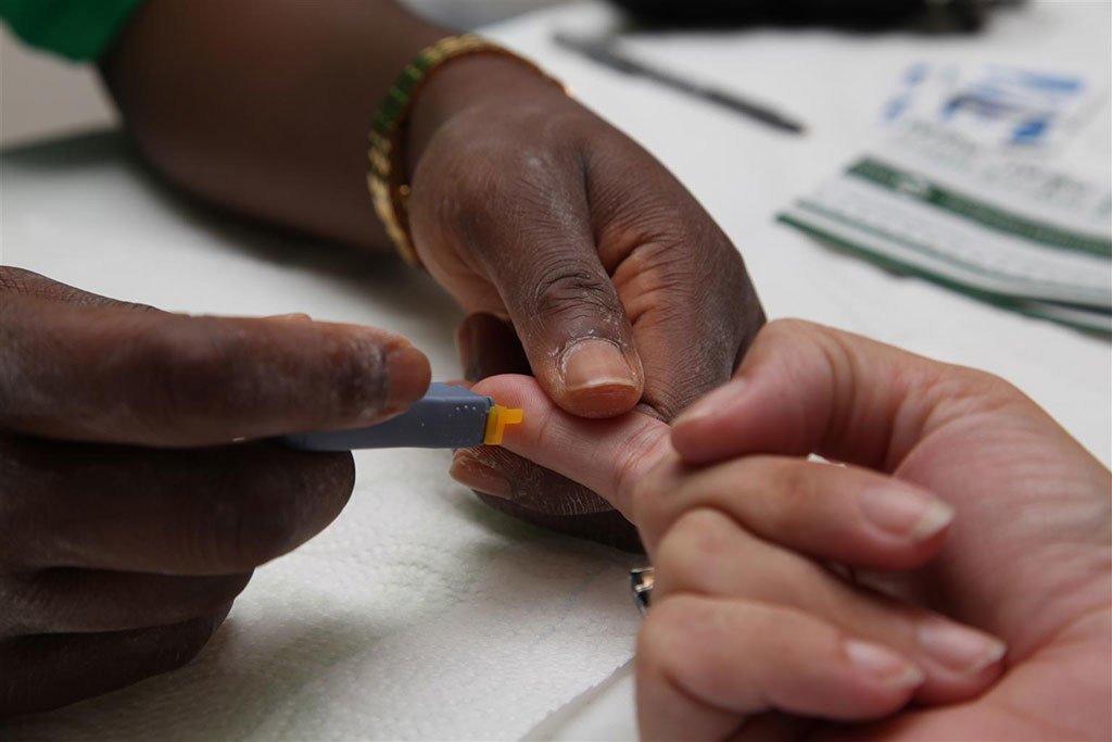 Un agent de santé effectue un test de dépistage pour les maladies sexuellement transmissibles, dont le VIH, sur un patient sur l'île de Saint-Martin.