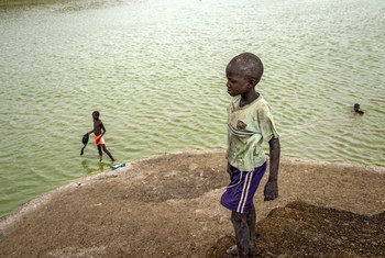 Children bathe in a lake formed by excavation pits in Bentiu, South Sudan. Nationwide, only 41 per cent of children have access to safe, clean water.