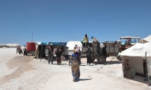 Displaced Syrians who recently fled the besieged city of Raqqa arrive in Ein Issa camp. Humanitarian workers work around the clock to overcome obstacles and to provide life-saving assistance to those in need.