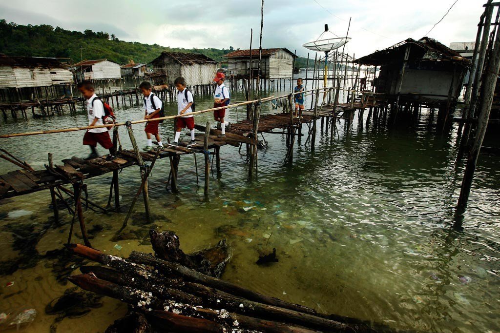 Children cross a bridge as they make their way to school in a remote part of the Sulawesi province, Indonesia.