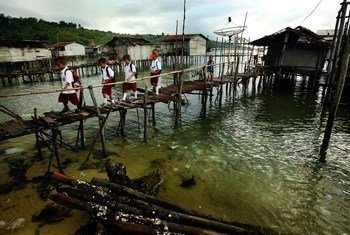 Children cross a bridge as they make their way to school in a remote part of the Sulawesi province, Indonesia.