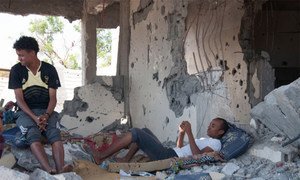 Yemeni family in their destroyed home.