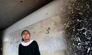 On 20 April 2016 in Gaza, Occupied Palestinian Territories, a student looks inside of one of the classrooms that was destroyed during the 2014 hostilities.