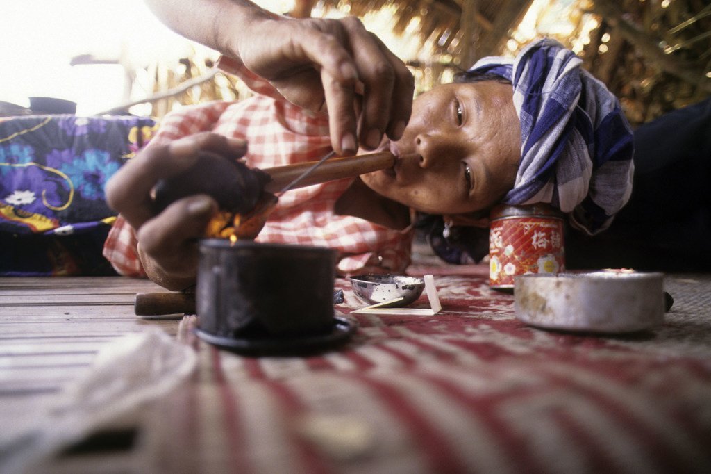 According to the INCB, only one in five women addicted to drugs are able to access treatment facilities. Seen here is a woman from a hill tribe in Thailand smoking opium (file).