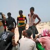 IOM staff assists Somali and Ethiopian migrants who were forced into the sea by smugglers.
