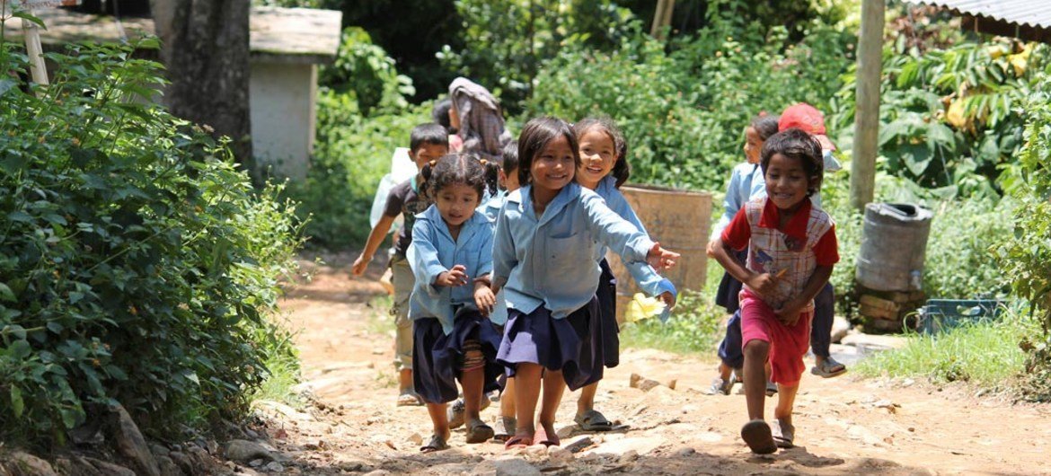 Young children play outside after the school day ends in rural Nepal.