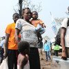 Families who fled militia attacks in Kasai Province in the Democratic Republic of the Congo arrive at the newly established Lóvua settlement in northern Angola.