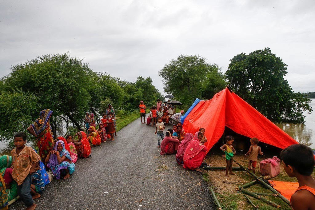 People displaced by the floods take temporary refuge along a road in southern Nepal.