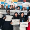 Staff stand together at United Nations Headquarters in New York to draw attention that civilians are #NotATarget.